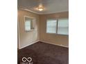 Living room area with multiple windows offering natural light and a modern ceiling fan at 2202 E Brookside Ave, Indianapolis, IN 46218