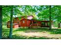 The property features a large backyard, wood deck and is surrounded by mature trees at 2240 Bill Smith Rd, Martinsville, IN 46151