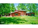 Charming home features a spacious yard, screened in porch, and mature trees at 2240 Bill Smith Rd, Martinsville, IN 46151