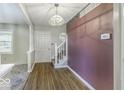 Welcoming foyer with wood floors and classic staircase, creating a charming entrance at 3134 W Hickory Woods Dr, Greenfield, IN 46140