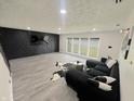 Spacious living area featuring a modern accent wall, plush seating, and an abundance of natural light at 3401 W Kessler Blvd N Dr, Indianapolis, IN 46222