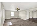 Spacious living room with ceiling fan, two closets with shelves and view of the neighboring dining area at 3609 N Keystone Ave, Indianapolis, IN 46218