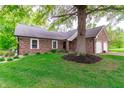 Traditional brick home with mature tree in the front yard and an attached two-car garage at 378 Turnberry Ct, Avon, IN 46123