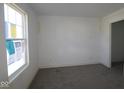 Unfinished bedroom with large window, featuring a neutral palette and natural light at 3942 Seeger St, Indianapolis, IN 46239