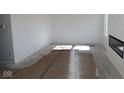 Unfinished living room featuring a modern fireplace and bright natural light at 3942 Seeger St, Indianapolis, IN 46239