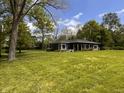 A single-story home in a large yard with many mature trees at 406 Frst Pk N Dr, Greenwood, IN 46142