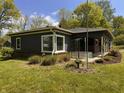 Side view of a single story home with mature landscaping at 406 Frst Pk N Dr, Greenwood, IN 46142