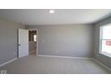 Bright bedroom with soft carpeting, a neutral color scheme, and a bright window providing ample natural light at 4075 Persian St, Greenwood, IN 46143