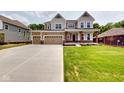 Traditional two-story home with a three-car garage and a long, paved driveway at 4075 Persian St, Greenwood, IN 46143