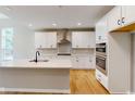 Modern kitchen with white cabinets, stainless steel appliances, and quartz countertops at 4075 Persian St, Greenwood, IN 46143