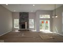Spacious living room featuring a stone fireplace and sliding doors, bathed in natural light at 4075 Persian St, Greenwood, IN 46143