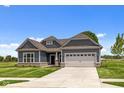 Beautiful gray one-story home with a well-maintained lawn and concrete driveway at 4076 Berry Chase Blvd, Greenwood, IN 46143