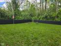Large, open backyard featuring a fire pit and a privacy fence, creating a serene outdoor space at 4644 N Ritter Ave, Indianapolis, IN 46226