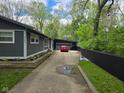 Shows the side exterior of the home, with a long driveway leading to a garage and backyard at 4644 N Ritter Ave, Indianapolis, IN 46226