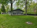 Charming single-story home with a spacious front yard, mature trees, and a welcoming landscape at 4644 N Ritter Ave, Indianapolis, IN 46226