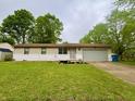 Charming single-story home with a well-maintained lawn and a two-car garage at 4718 Tempe Ct, Indianapolis, IN 46241