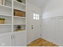 Bright entryway with hardwood floors, built-in shelving, and stylish wainscoting at 4725 Boulevard Pl, Indianapolis, IN 46208