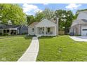 Inviting single-story home with a welcoming front porch and lush green lawn at 4725 Boulevard Pl, Indianapolis, IN 46208