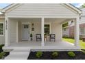 Charming front porch with seating, offering a cozy and inviting outdoor space at 4725 Boulevard Pl, Indianapolis, IN 46208