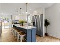 Modern kitchen featuring a large island with seating, stainless steel appliances, and white cabinetry at 4725 Boulevard Pl, Indianapolis, IN 46208