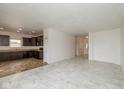 Open-concept living space with a kitchen featuring dark wood cabinets, connecting to a spacious area at 4752 Chip Shot Ln, Indianapolis, IN 46235