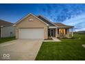 Charming single-story home with brick facade, attached garage, green lawn, and evening sky at 505 Shallowroot Ln, Sheridan, IN 46069