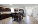 Open kitchen with wooden cabinetry, stainless steel appliances, and dining area at 509 Tulip Tree Dr, Lapel, IN 46051
