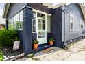 Inviting front entrance features a stylish door, potted plants, and a well-maintained walkway at 5241 Guilford Ave, Indianapolis, IN 46220