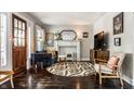 Bright living room boasts a decorative fireplace, ample seating, and a decorative rug at 5241 Guilford Ave, Indianapolis, IN 46220