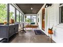 Bright sunroom featuring neutral furniture, plants, and natural light at 5241 Guilford Ave, Indianapolis, IN 46220
