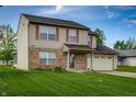 Traditional two-story home featuring brick accents, shutters and an attached two-car garage at 5351 Eel River Ct, Indianapolis, IN 46221