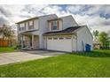Well-maintained two-story home with an attached two-car garage and brick and siding facade at 5351 Eel River Ct, Indianapolis, IN 46221