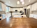 Spacious kitchen with an island, granite countertops, stainless steel appliances, and white cabinetry at 6309 Harvey Dr, Plainfield, IN 46168