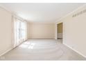 Bright living room with neutral carpet, large window and trim throughout at 6530 Kingswood Dr, Indianapolis, IN 46256