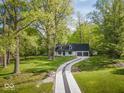 Charming two-story home in a lovely wooded area with a long driveway at 6682 English Dr, Avon, IN 46123