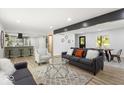 Open living area with modern decor, wood floors, and view into updated kitchen at 6682 English Dr, Avon, IN 46123
