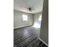 Cozy bedroom featuring modern vinyl floors and ample natural light from two large windows at 728 Lonsvale Dr, Anderson, IN 46013