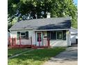 Charming single-story home featuring a red porch, well-maintained lawn, and a detached garage at 728 Lonsvale Dr, Anderson, IN 46013