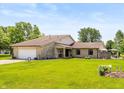 Charming stone home with a well-maintained lawn and inviting curb appeal at 8111 Timberwood Dr, Plainfield, IN 46168
