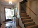 Bright foyer with staircase, tiled floor, and decorative accents at 8111 Timberwood Dr, Plainfield, IN 46168