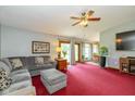 Comfortable living room with a gray sofa, TV, and sliding glass doors at 8111 Timberwood Dr, Plainfield, IN 46168