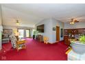 Spacious living room with a TV, ceiling fan, and an adjoining office at 8111 Timberwood Dr, Plainfield, IN 46168