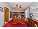Inviting home office with wood built-ins, a ceiling fan, and a bright window at 8111 Timberwood Dr, Plainfield, IN 46168