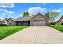 Well-manicured front yard and attached garage compliment this beautiful one-story brick home at 815 Stewart Rd, Anderson, IN 46012