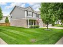 Well-maintained home with a spacious front yard, manicured lawn, and mature tree at 8704 New Heritage Dr, Indianapolis, IN 46239