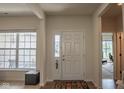 Bright foyer with natural light, hardwood floors, white door and trim, with views into other rooms at 8732 Wicklow Way, Brownsburg, IN 46112