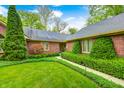 Beautiful brick home with manicured landscaping and a welcoming walkway leading to the front entrance at 9324 W Point Pl, Indianapolis, IN 46268