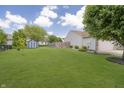 Large, grassy backyard with a storage shed and partial fencing offering ample space for outdoor activities at 1008 Canary Creek Ct, Franklin, IN 46131