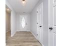 Bright entryway with light wood floors and white trim, leading into the main living areas at 1008 Canary Creek Ct, Franklin, IN 46131