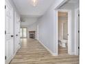 Hallway view showcasing updated flooring, bathroom access and entry to the living room with fireplace at 1008 Canary Creek Ct, Franklin, IN 46131